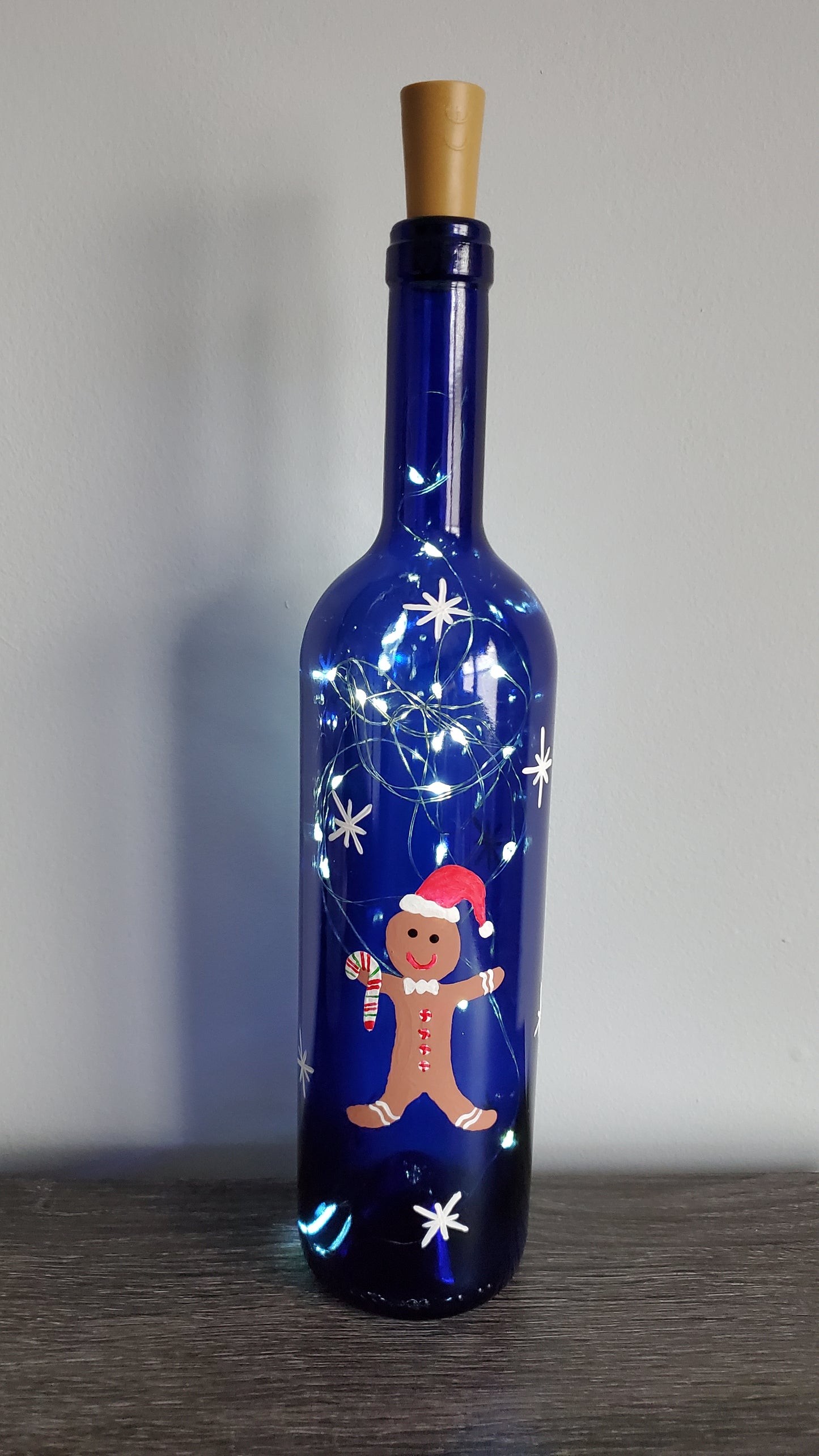 Gingerbread man lighted wine bottle